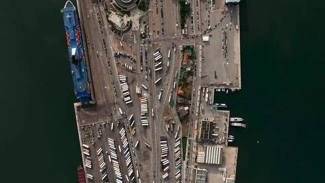 Olbia - Italy - Sardinia - 10 June 2022. Aerial view of the touristic and industrial port with line ferries in the harbour and urban panorama of the city