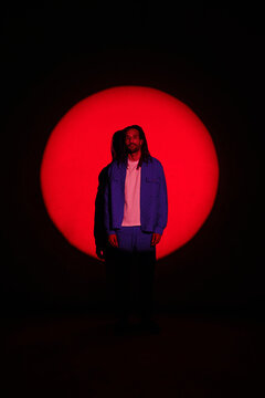 Stylish man under red light