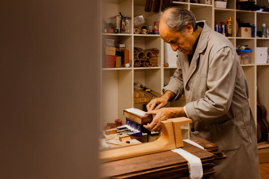 Mature carpenter using tablet in workshop - Powered by Adobe