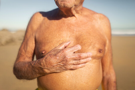 senior man in swimming trunks on the beach
