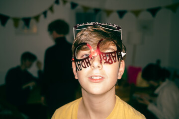 boy with birthday glasses