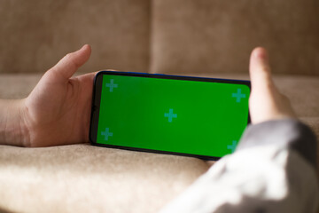 A child is using a phone with a chroma key screen mockup.