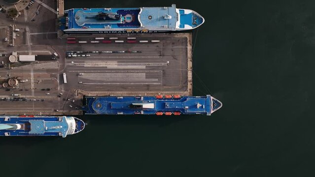 Olbia - Italy - Sardinia - 10 June 2022. Aerial view of the touristic and industrial port with line ferries in the harbour and urban panorama of the city