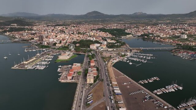 Olbia - Italy - Sardinia - 10 June 2022. Aerial view of the touristic and industrial port with line ferries in the harbour and urban panorama of the city