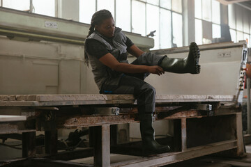 Serious woman standing in marble workshop