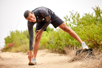 Stretching legs, exercise and man on nature trail for running, marathon training and cardio workout. Sports, healthy body and portrait of happy male athlete warm up for wellness, exercise and balance