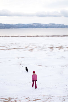  Woman walking with her dog in winter