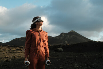 Woman with VR glasses and joysticks in Metaverse