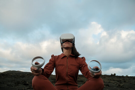 Portrait of woman with VR glasses and joysticks