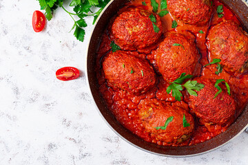 Lazy cabbage rolls stewed in sweet and sour tomato sauce. Meatballs. Beef cutlet. Top view