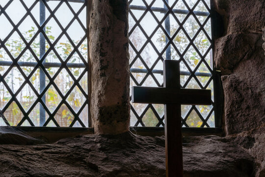 A cross by a window in an ancient church