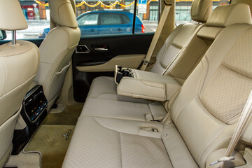Modern car inside. Leather passenger seats with opened armrest. Comfortable leather seats. Central armrest for rear seat