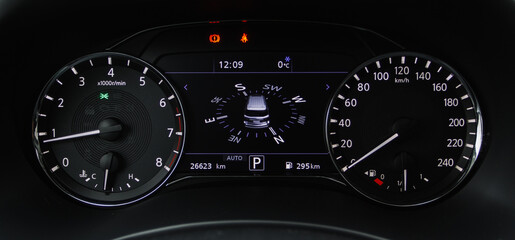 Сompass on the digital dashboard of modern car. Modern digital car mileage. GPS navigation.