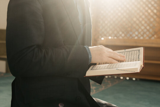 man holding Quran