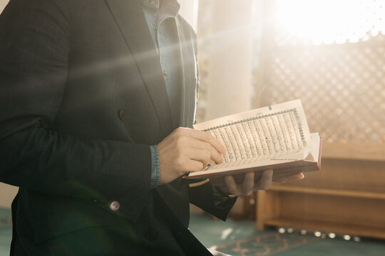 man holding Quran