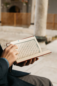 man holding Quran