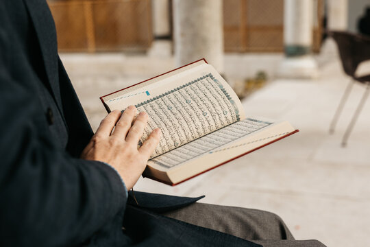 man holding Quran