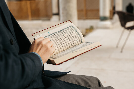man holding Quran