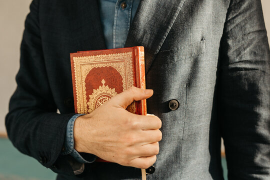 man holding Quran