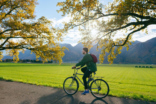 Man riding vintage bicycle on sunny autumn day