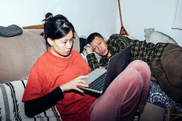 Couple using computer together at home