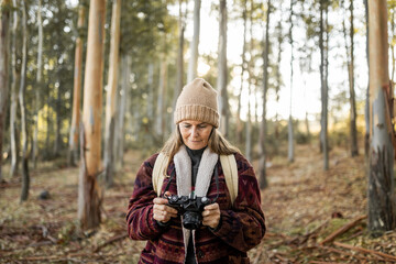 mature woman taking photos in nature