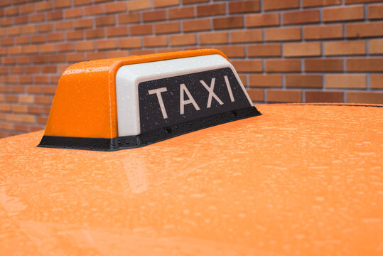 Orange taxi on a rainy day