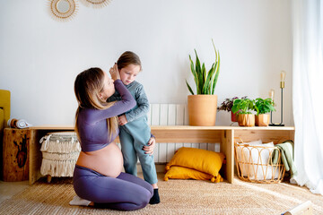 Pregnant mom comforts her angry daughter at home