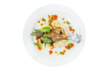 Fried chicken with mashed potatoes, herbs and sauces in a white plate. Appetizing traditional dish. Top view. Close-up. Isolated on white background.