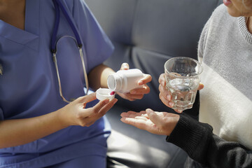  consulting female patient about pills and discussing health treatment sitting in the office at the desk. Medicine and health care concept. Doctor prescribing medicine to patient in the office.