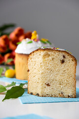Easter brioche with swiss meringue and spring decoration, orange tulips on background. Happy Easter. Recipe of Easter bakery. Festive pastry for spring holidays.