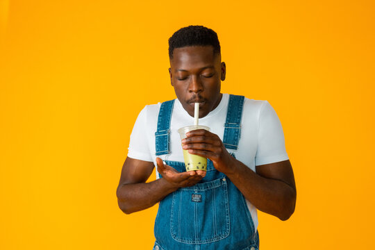 Black guy drinking takeaway boba tea