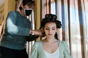 Hairstylist doing hair of female client