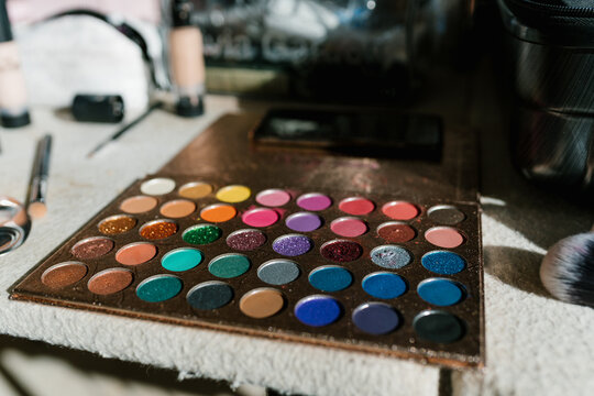 Palette of colorful eyeshadows on table