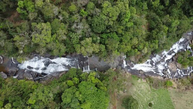 Movement with drone and camera pointed down filming a beautiful waterfall, exuberant nature