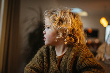 girl with blond curls looking worried