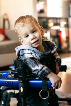 Child In Therapy Walker Looks At Camera