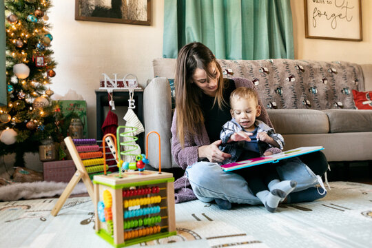 Mother Reads Book To Child With Cerebral Palsy
