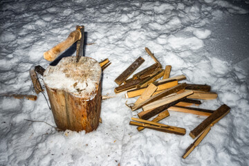 Chopping Firewood With Axe In Winter Snow