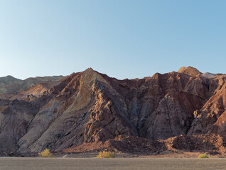 View of amazing colored mountains from a road toward the Dasht-e Lut desert in Iran