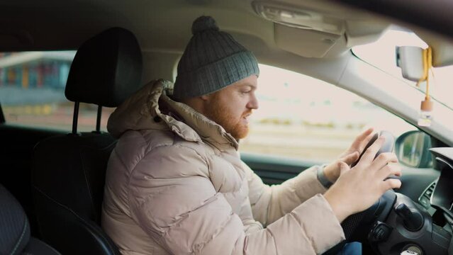 Angry driver in a traffic jam. He screams and gesticulates,
