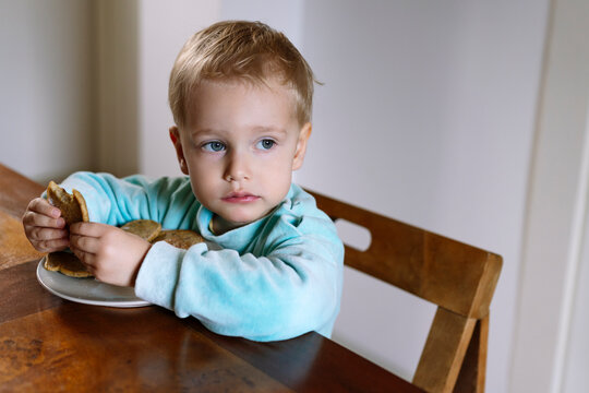 Little child eats pancakes 