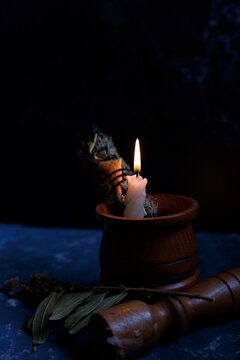 A close up image of a burning herb wand bundle
