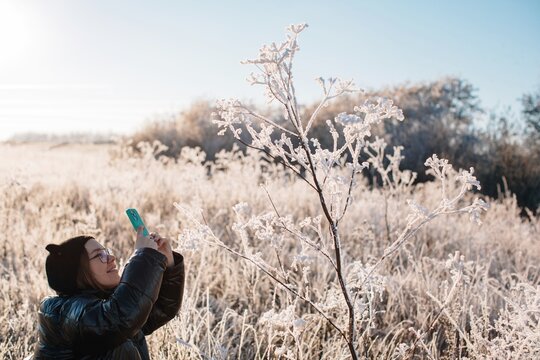 Young model taking pictures of winter nature