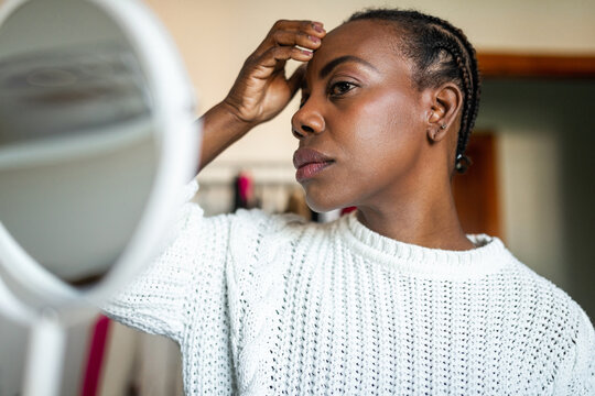 Black Woman Doing Makeup At Home