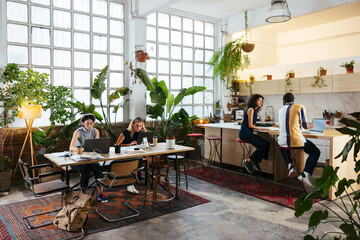 Group of colleagues working on creative workspace