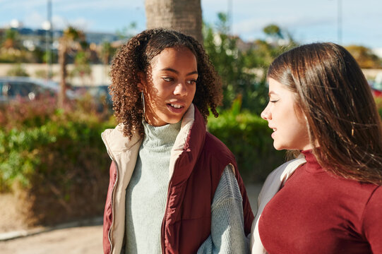 Smiling teens talking outdoors 