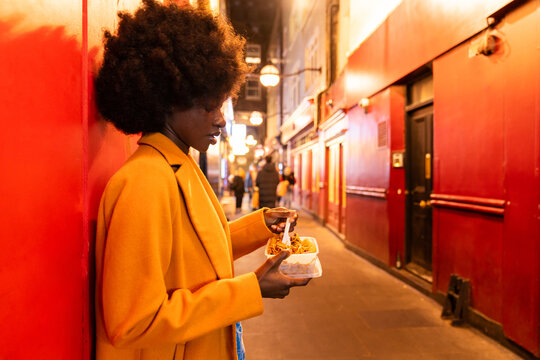 Candid Image Of Woman Eating Street Food 