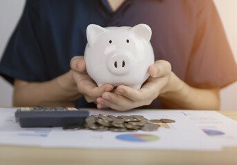man with piggy bank The concept of bank account savings and investments to maximize profits.	