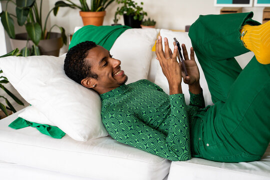 Man relaxing at home using phone